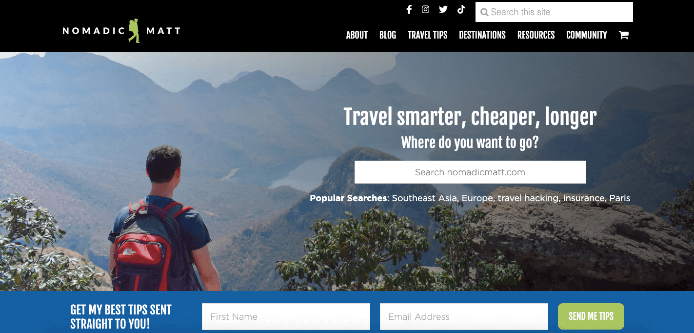 A screenshot of Nomadic Matt’s website featuring a man wearing a red backpack starting at the mountains with the tagline, “Travel smarter, cheaper, longer.”